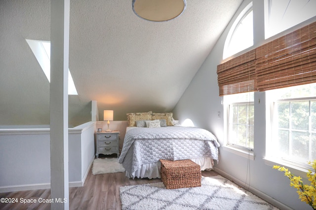 bedroom featuring a textured ceiling and light wood-type flooring