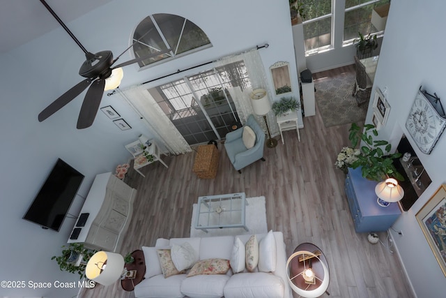 living area with ceiling fan and wood finished floors