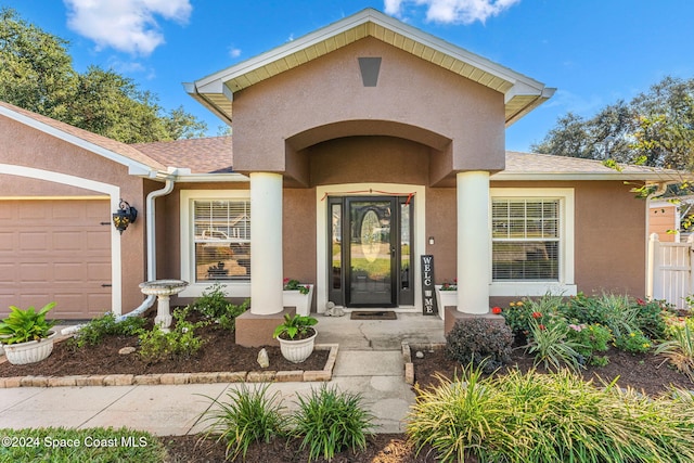 view of exterior entry with a garage