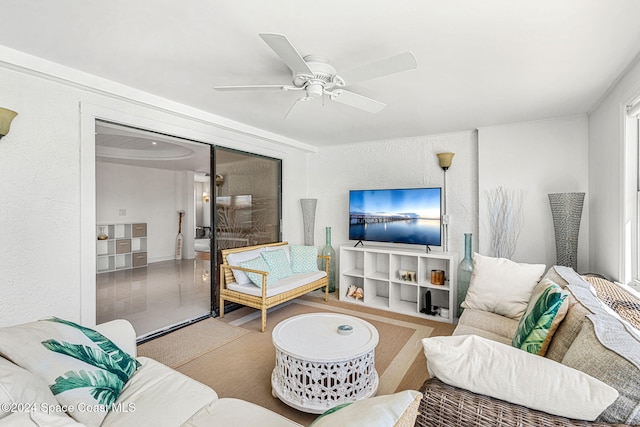 living room featuring ceiling fan and light tile patterned floors