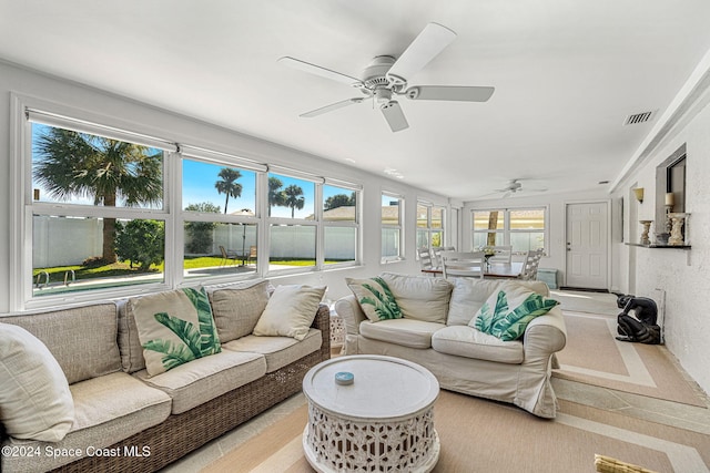 sunroom / solarium featuring ceiling fan