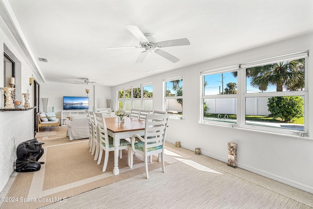 sunroom with ceiling fan and a healthy amount of sunlight