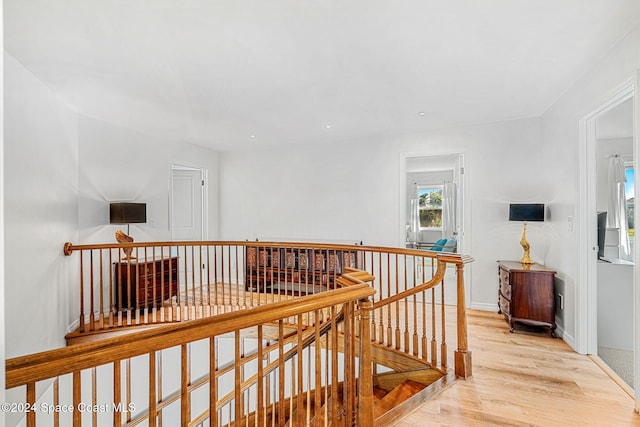 hallway with light hardwood / wood-style flooring