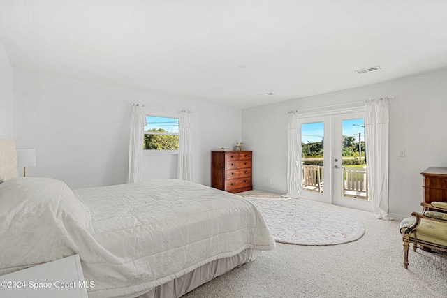 bedroom with carpet floors, french doors, access to outside, and multiple windows