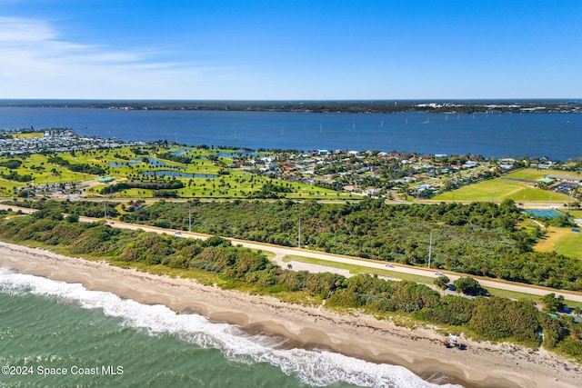 birds eye view of property featuring a water view and a beach view