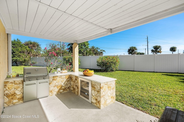 view of patio with wine cooler, grilling area, and an outdoor kitchen