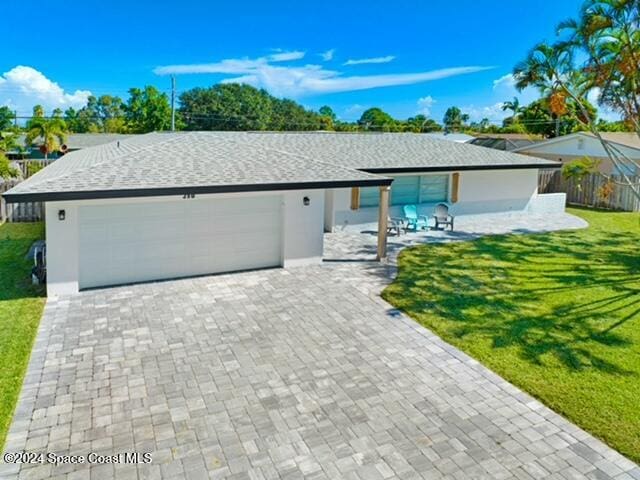 ranch-style house with a front yard and a garage