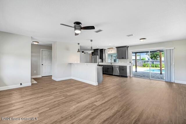 unfurnished living room with dark hardwood / wood-style floors and ceiling fan