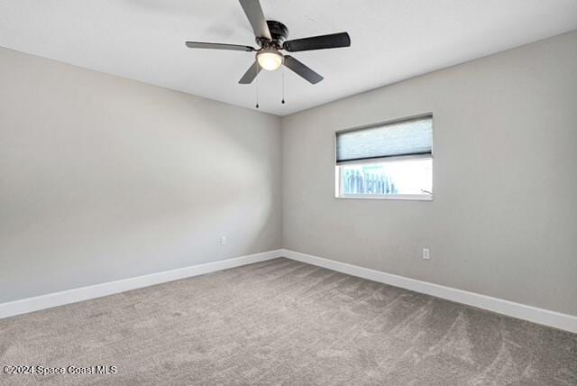 spare room featuring ceiling fan and carpet floors