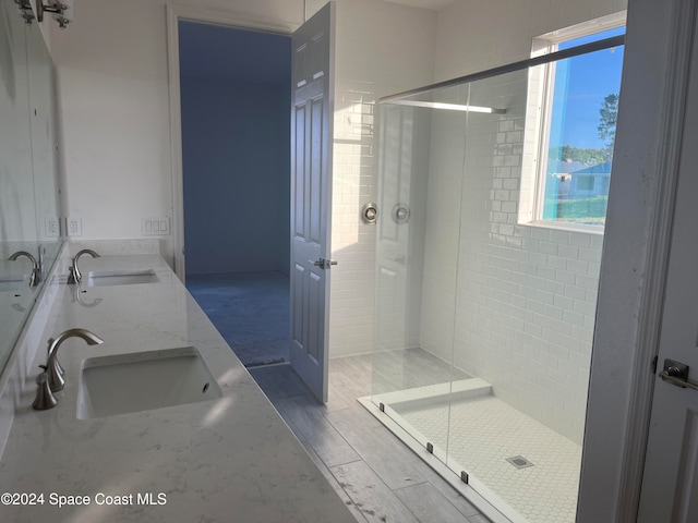 bathroom featuring vanity, hardwood / wood-style flooring, and walk in shower