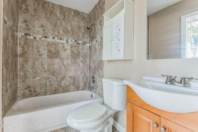 full bathroom featuring vanity, toilet, and tiled shower / bath