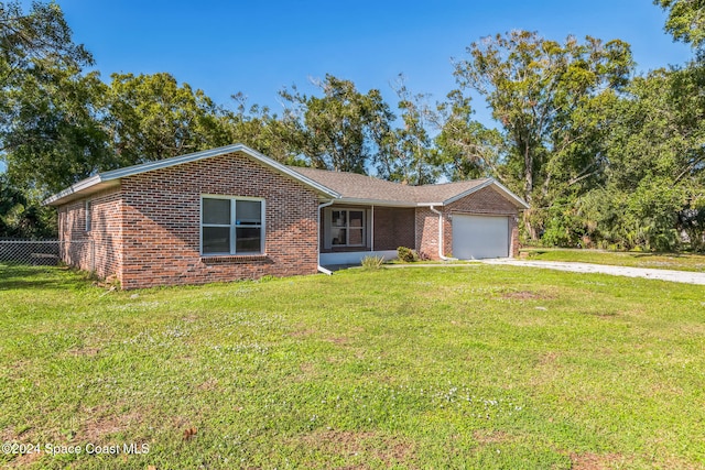 single story home with a garage and a front lawn