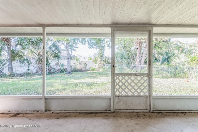 unfurnished sunroom with wooden ceiling