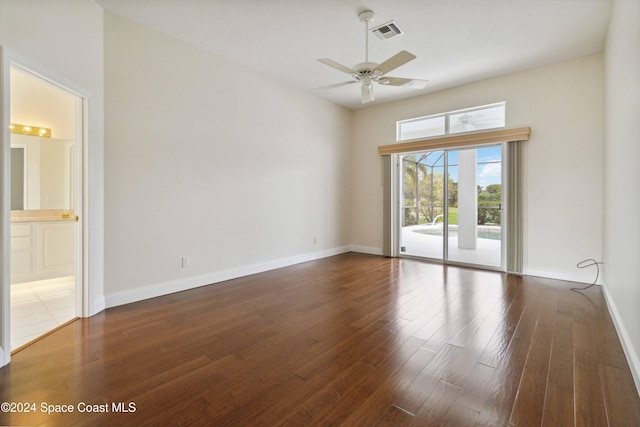 empty room with dark hardwood / wood-style flooring and ceiling fan