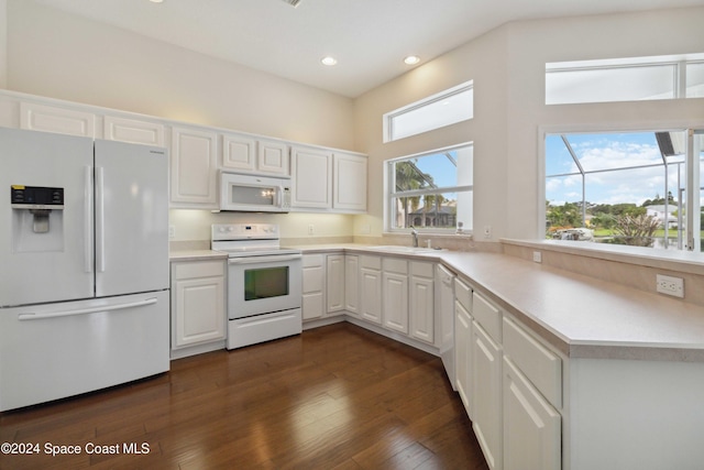 kitchen with white appliances, dark hardwood / wood-style floors, white cabinetry, and a healthy amount of sunlight