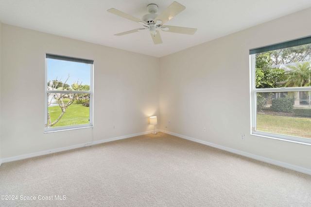 empty room with carpet flooring and ceiling fan