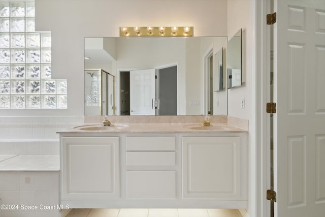 bathroom featuring tile patterned floors, vanity, and an enclosed shower