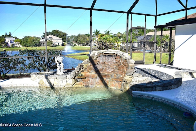 view of pool featuring pool water feature, a lanai, and a water view