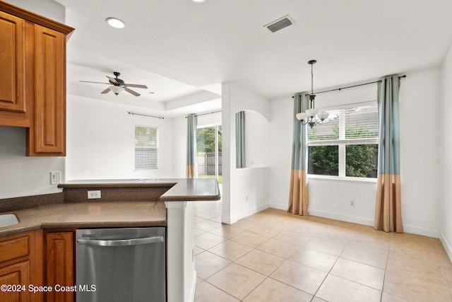 kitchen with a wealth of natural light, light tile patterned flooring, decorative light fixtures, and ceiling fan with notable chandelier