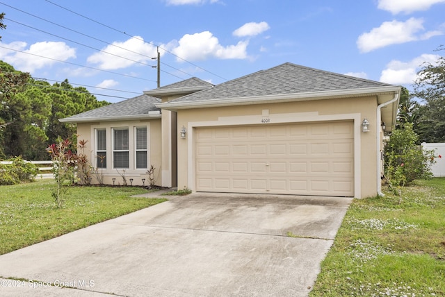 ranch-style house with a garage and a front yard