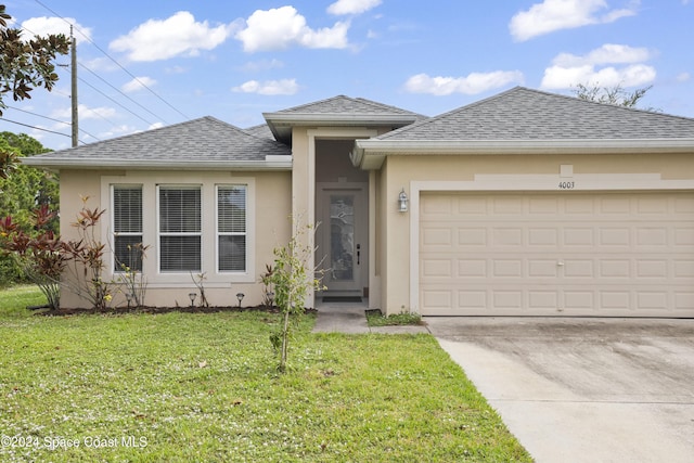 prairie-style home with a front lawn and a garage