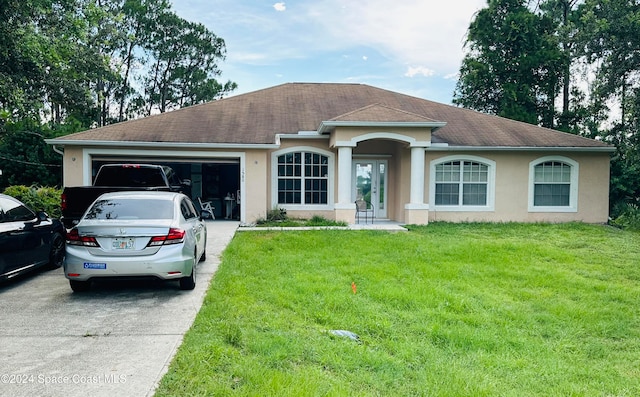 ranch-style house featuring a garage and a front yard