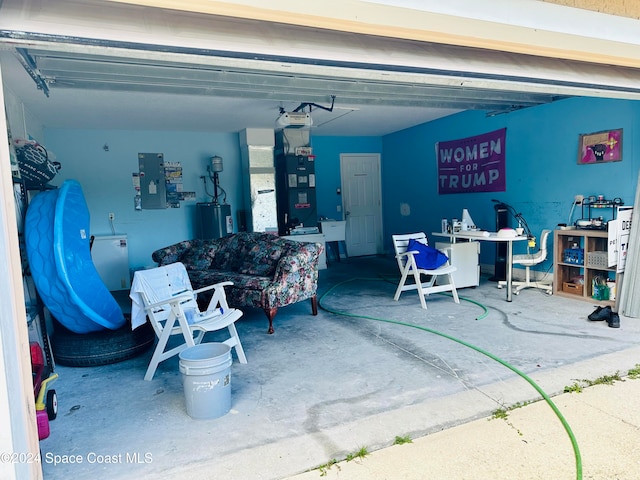 garage featuring electric water heater, electric panel, and heating unit