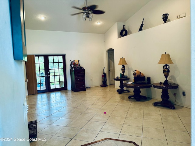 interior space featuring light tile patterned floors, french doors, high vaulted ceiling, and ceiling fan