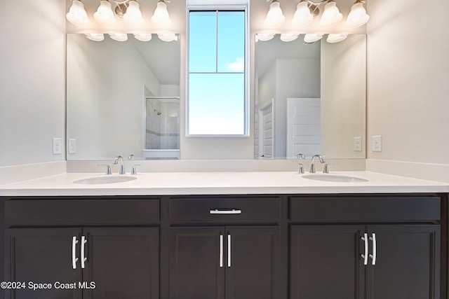 bathroom featuring walk in shower, vanity, and a wealth of natural light