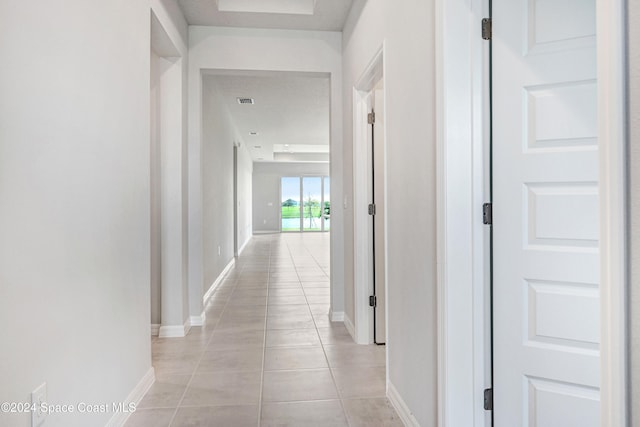 corridor with light tile patterned floors