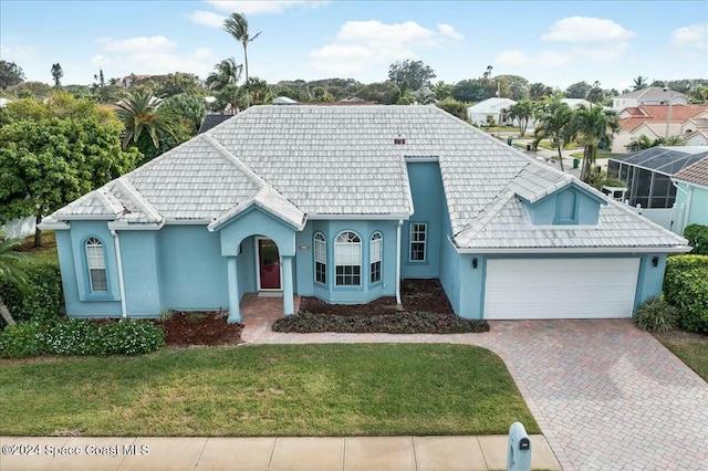 view of front of property with a garage and a front lawn