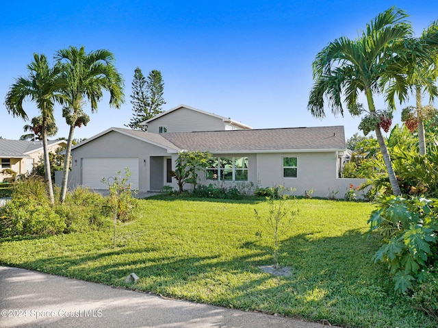 379 Hiawatha Way, Melbourne Beach, FL 32951 - ranch-style house with stucco siding, a garage, and a front lawn