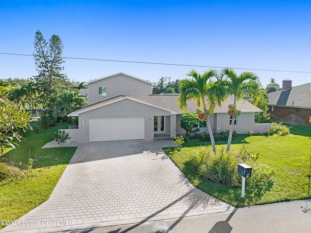 379 Hiawatha Way, Melbourne Beach, FL 32951 - view of front of home with a garage, stucco siding, decorative driveway, and a front lawn