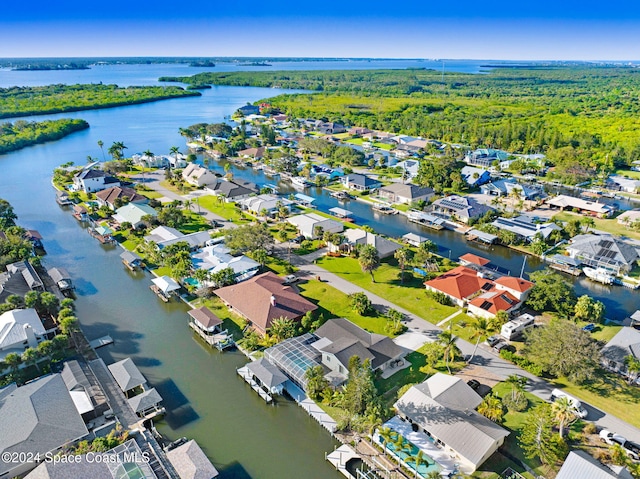 379 Hiawatha Way, Melbourne Beach, FL 32951 - aerial view of residential area featuring a nearby body of water and a heavily wooded area