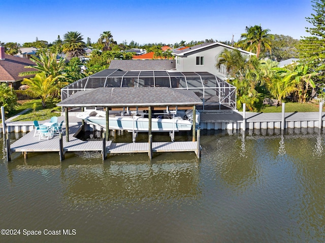 view of dock with a lanai and a water view