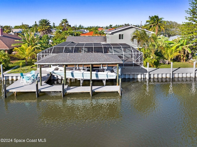 379 Hiawatha Way, Melbourne Beach, FL 32951 - dock area featuring boat lift, a water view, and a lanai