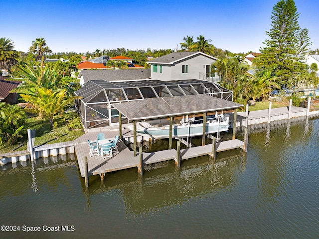 379 Hiawatha Way, Melbourne Beach, FL 32951 - dock area with a water view, boat lift, a lanai, and a swimming pool