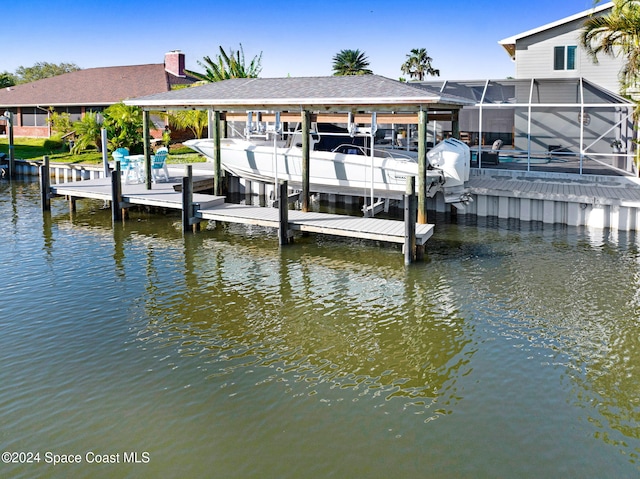 379 Hiawatha Way, Melbourne Beach, FL 32951 - dock featuring a water view, boat lift, and a lanai