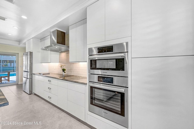 379 Hiawatha Way, Melbourne Beach, FL 32951 - kitchen featuring modern cabinets, stainless steel appliances, wall chimney range hood, white cabinets, and recessed lighting