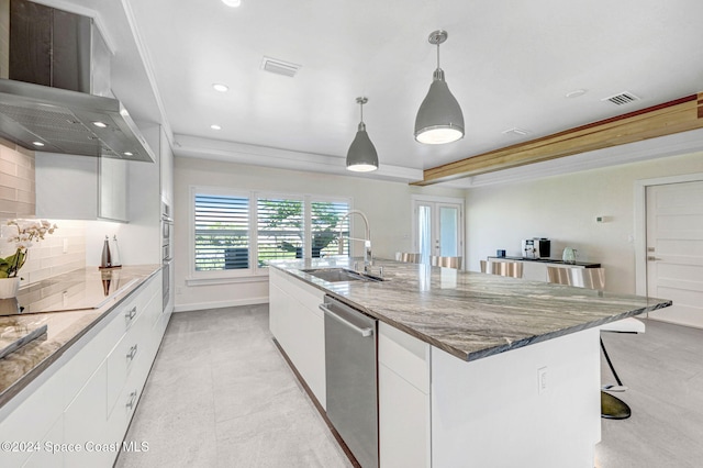379 Hiawatha Way, Melbourne Beach, FL 32951 - kitchen with dishwasher, wall chimney range hood, white cabinets, black electric stovetop, and recessed lighting