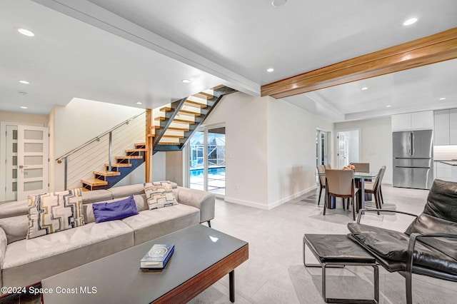 living room featuring light carpet and beam ceiling