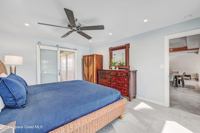 379 Hiawatha Way, Melbourne Beach, FL 32951 - bedroom with recessed lighting, a ceiling fan, a barn door, and light tile patterned floors