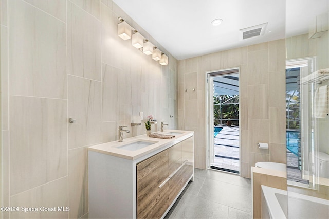 bathroom with vanity and tile walls