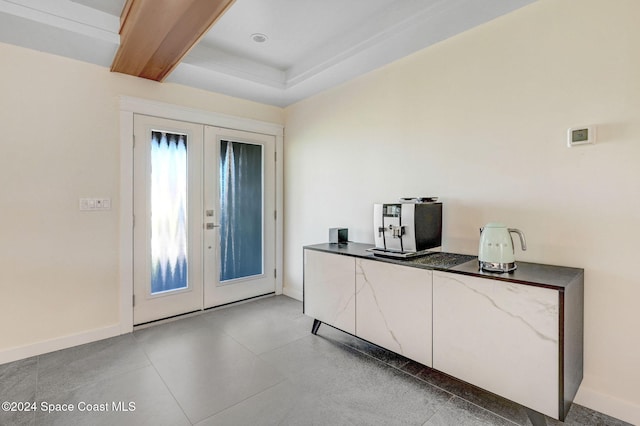 foyer entrance featuring french doors and beamed ceiling