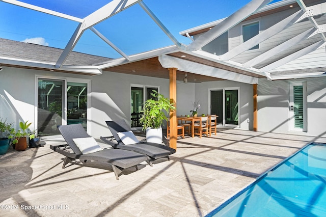 back of house featuring a patio area, ceiling fan, and glass enclosure