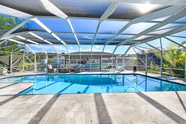 view of swimming pool featuring glass enclosure and a patio area