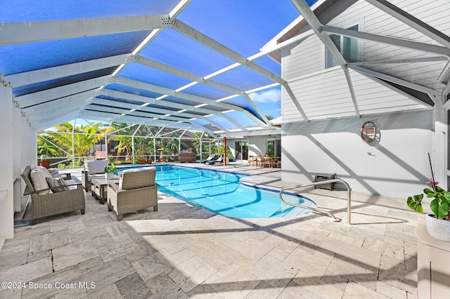 view of pool featuring a lanai, a patio area, and an outdoor living space