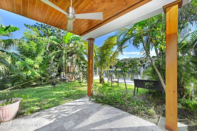 view of patio / terrace with ceiling fan and a water view