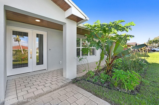 entrance to property with a lawn