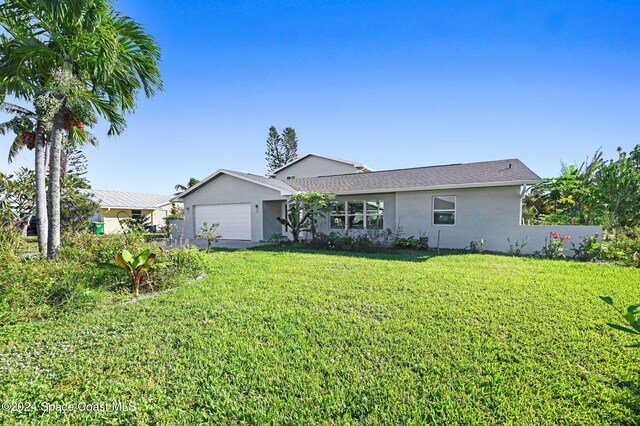 ranch-style home featuring a front yard and a garage